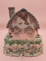 Vintage ABC Easter bunny cottage figurine with lighted house, animated bunnies, and music box that plays 