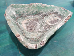 Carved green and purple fluorite crystal bowl with raw edge