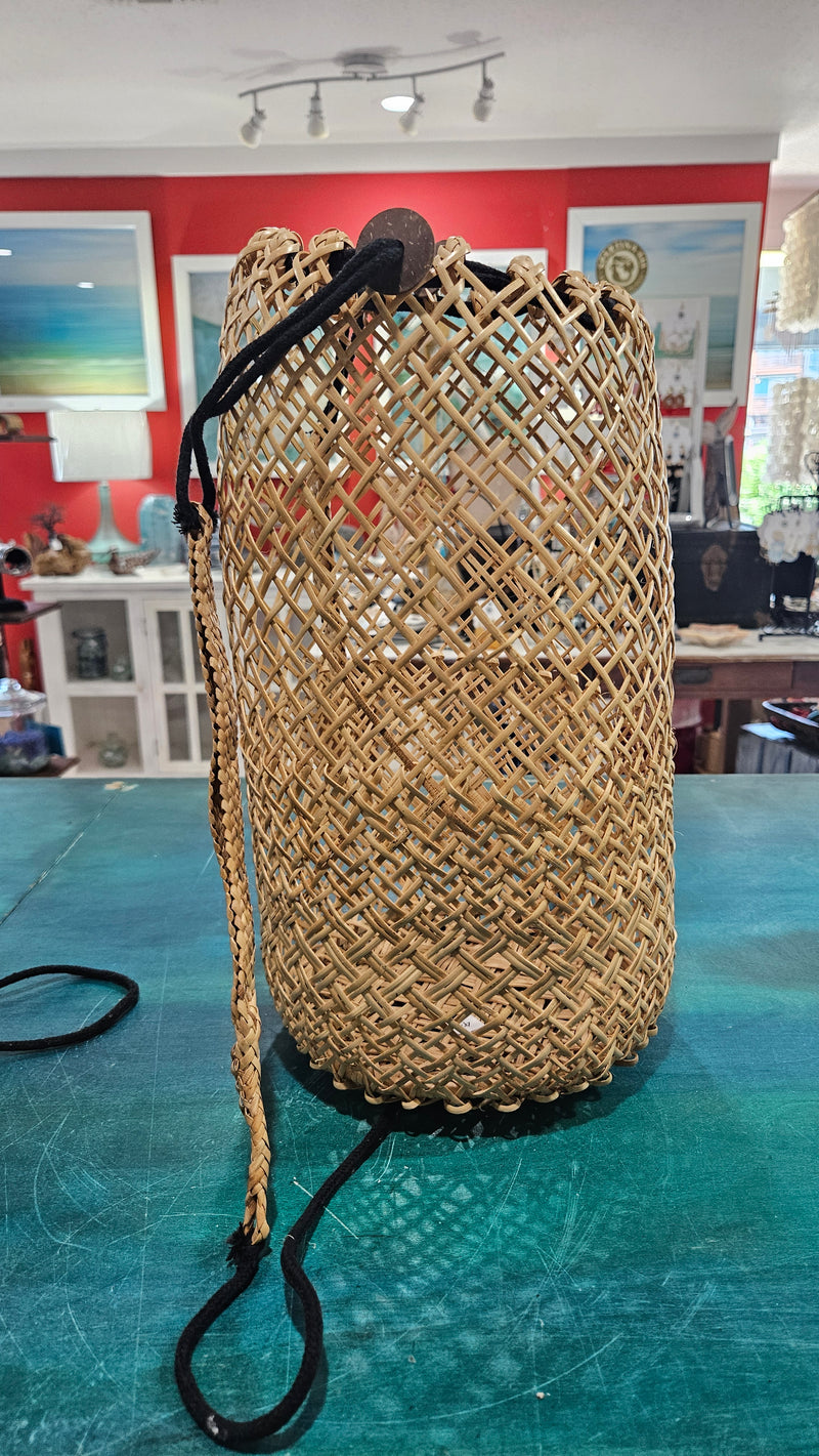 handwoven rattan backpack basket with natural braided straps and open lattice pattern 