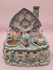 Vintage ABC Easter bunny cottage figurine with lighted house, animated bunnies, and music box that plays 