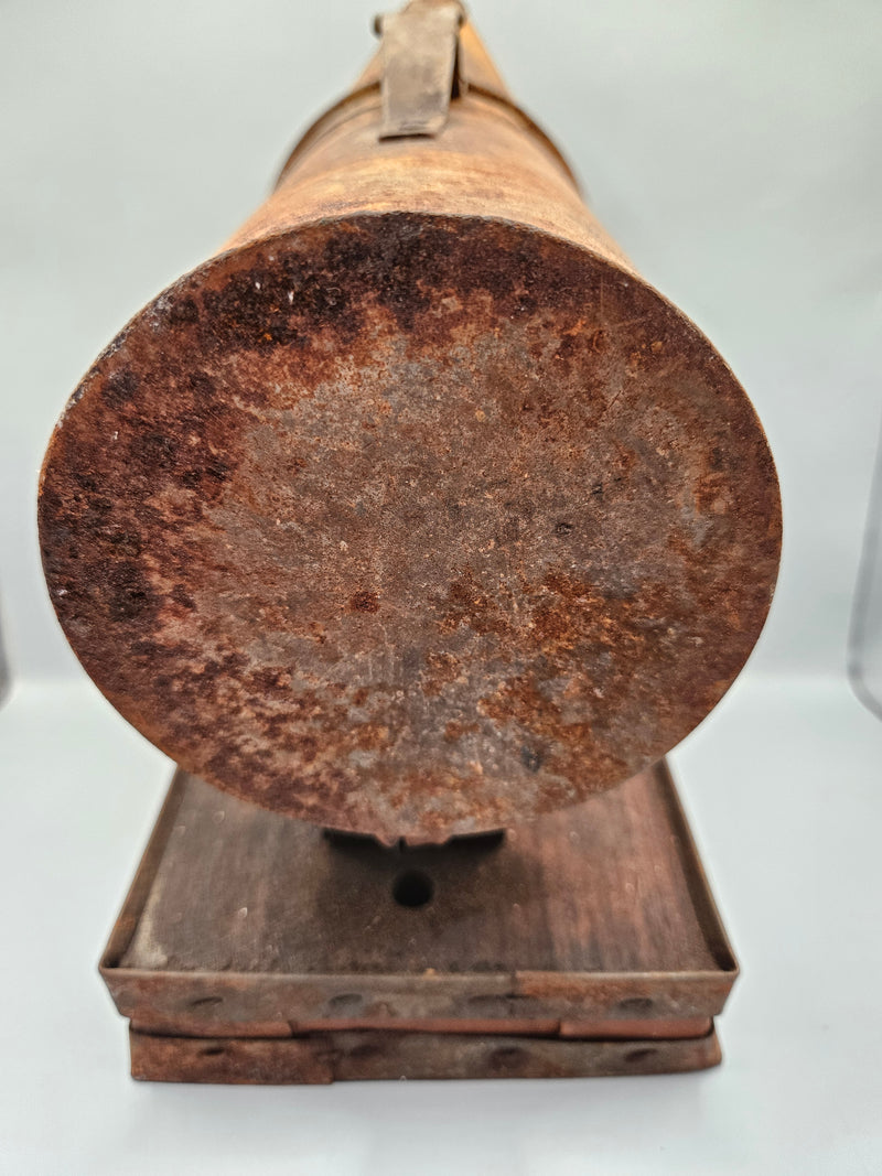 A vintage metal beekeeping smoker with a cone-shaped spout and rectangular body. The piece has a rustic, aged patina with visible rivets, making it a unique collectible or décor item for vintage and industrial-themed spaces