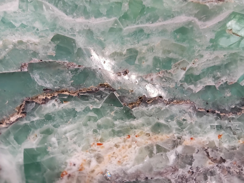 Carved green and purple fluorite crystal bowl with raw edge