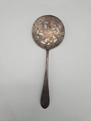 A vintage International Silver Co. Original Rogers slotted serving spoon with a natural patina, measuring 7.5