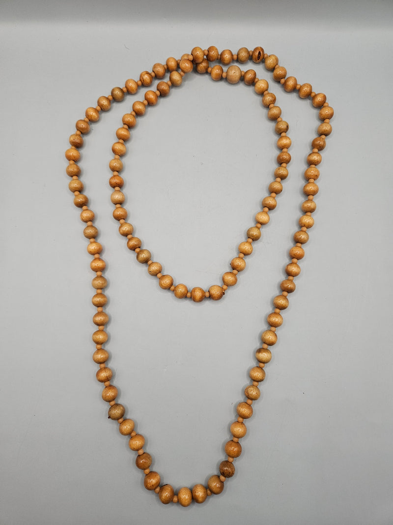 A vintage 24" wood bead necklace featuring natural wooden beads in a boho style