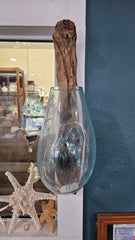 Wall-hanging teak wood and molten glass terrarium. Handcrafted design with molten glass fused to a natural teak wood base, creating a unique and rustic aesthetic. Perfect for displaying plants, flowers, or decorative items