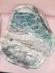 and-carved fluorite bowl featuring layers of green, purple, and aqua crystal