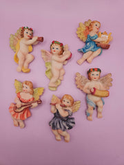 angel baby magnets, each hand-painted with pastel colors, playing musical instruments