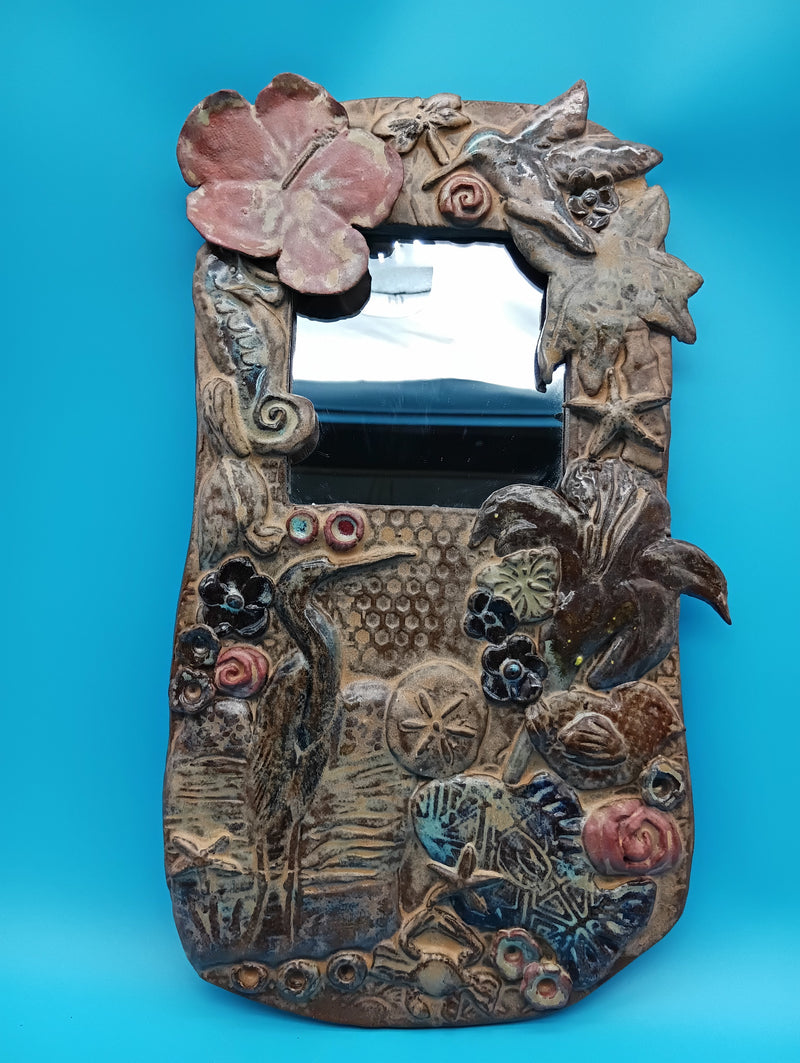 Handmade ceramic coastal mirror with hibiscus, heron, shells, and sand dollar – 13.5" x 8"