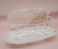Polished onyx dish with natural cream veining on pink background