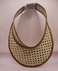  woven rattan visors with faux leather trim in black, red, green, and brown