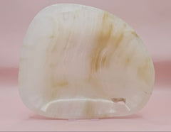 Cream and beige polished onyx dish with soft banded veining 