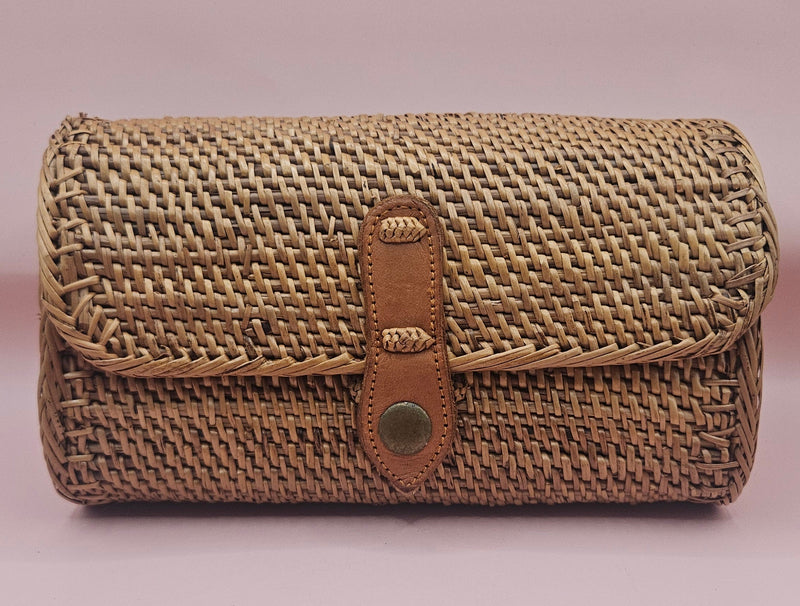 Handwoven rattan clutch with leather strap closure