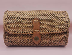 Handwoven rattan clutch with leather strap closure