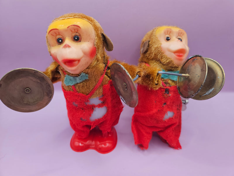 Vintage wind-up monkey toy for parts or restoration, featuring cymbals, red clothing, and visible wear, ideal for DIY or collectors