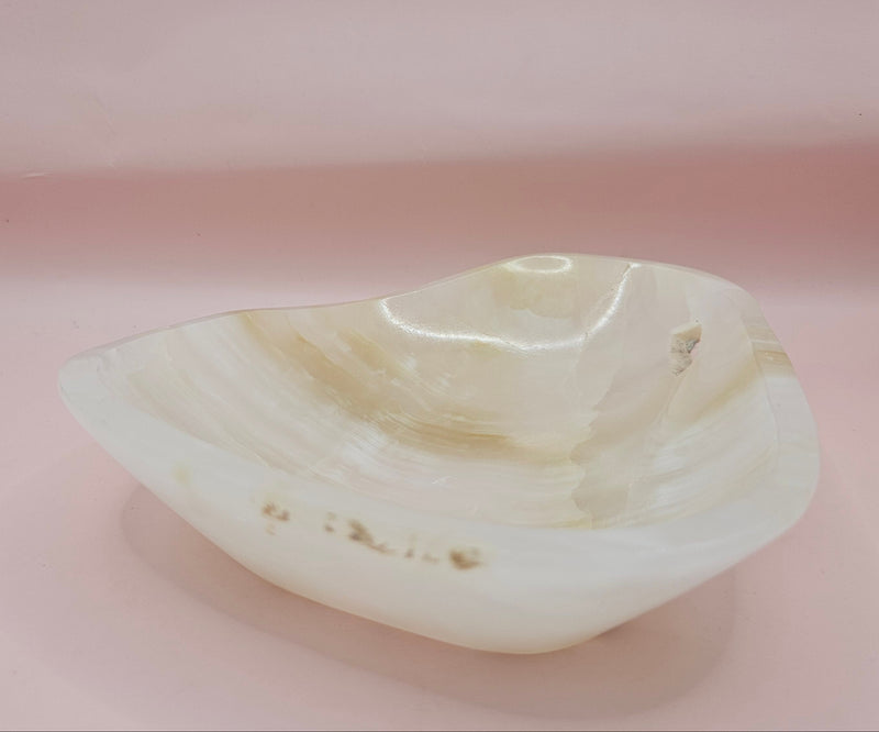 Cream and beige polished onyx dish with soft banded veining 