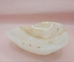 Cream and beige polished onyx dish with soft banded veining 