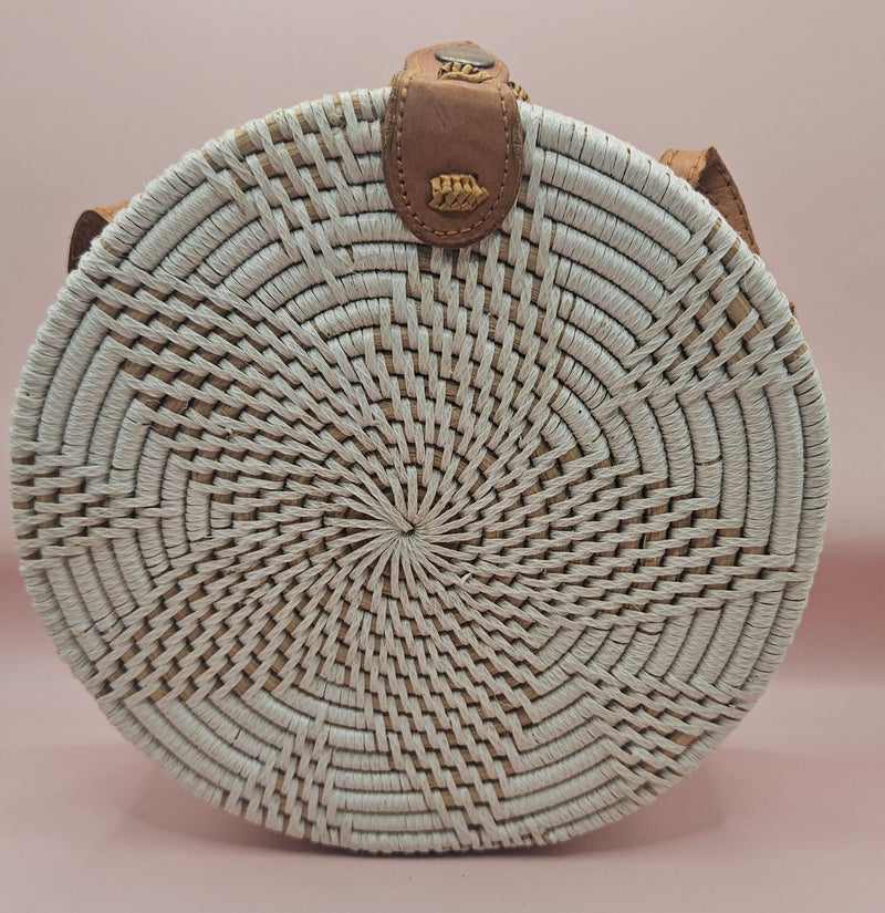 Round rattan crossbody bags in 4 styles—natural, pink, whitewash, and floral weave—with fabric-lined interior