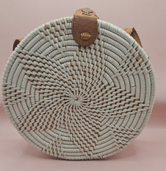 Round rattan crossbody bags in 4 styles—natural, pink, whitewash, and floral weave—with fabric-lined interior