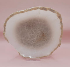 small raw-edge onyx dishes with soft cream coloring and polished finish on pink background