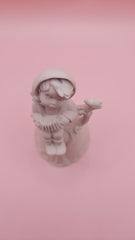 Unpainted vintage ceramic bisque bell featuring a boy with accordion sitting on a tree with bird detail, Provincial Mold #P-447, 4.8x2.8 inches.