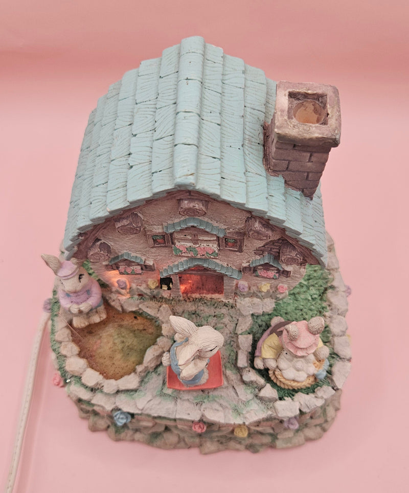Vintage ABC Easter bunny cottage figurine with lighted house, animated bunnies, and music box that plays "Easter Parade" – ceramic 6-inch display