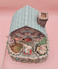 Vintage ABC Easter bunny cottage figurine with lighted house, animated bunnies, and music box that plays 