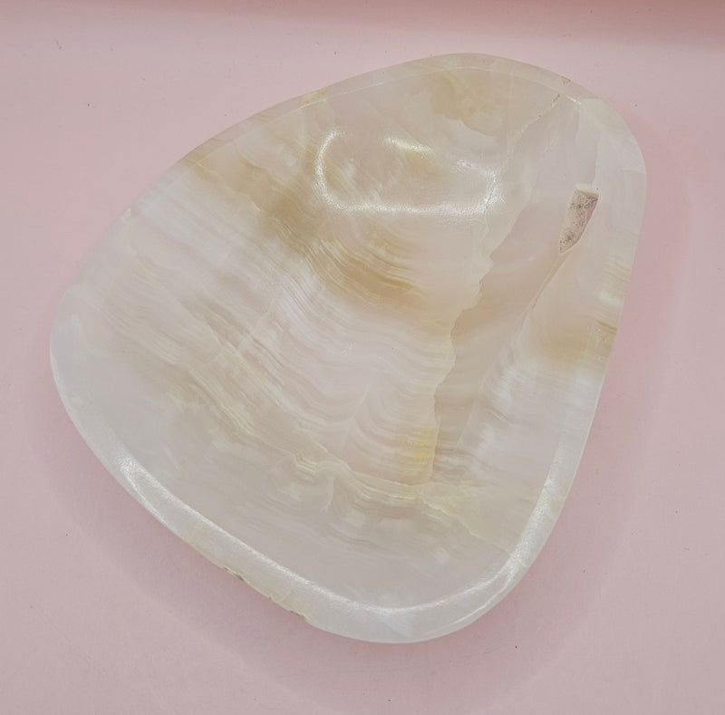 Cream and beige polished onyx dish with soft banded veining 