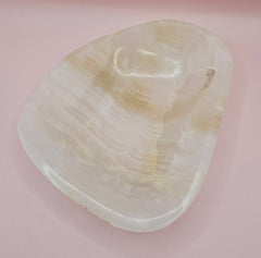 Cream and beige polished onyx dish with soft banded veining 