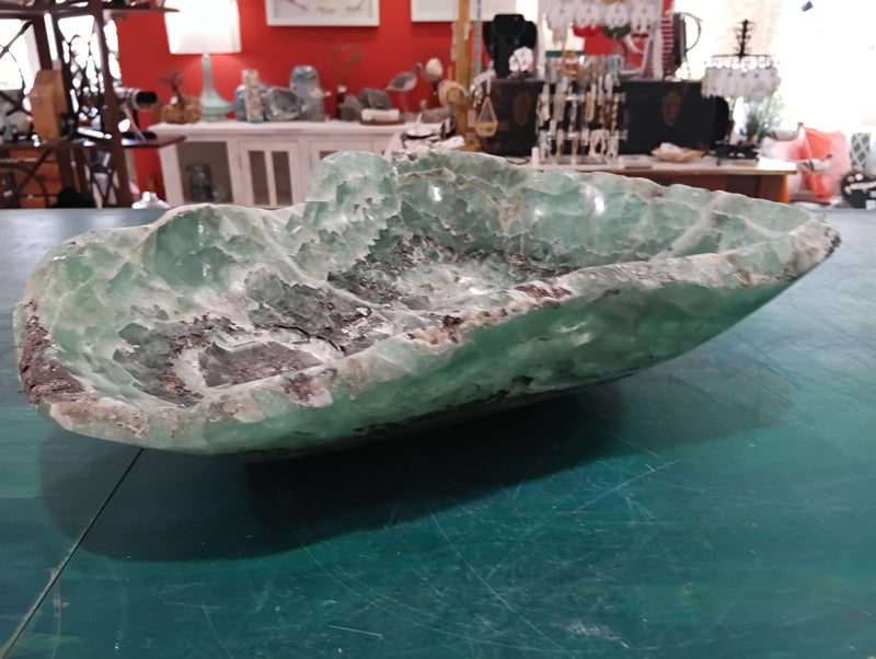 Carved green and purple fluorite crystal bowl with raw edge