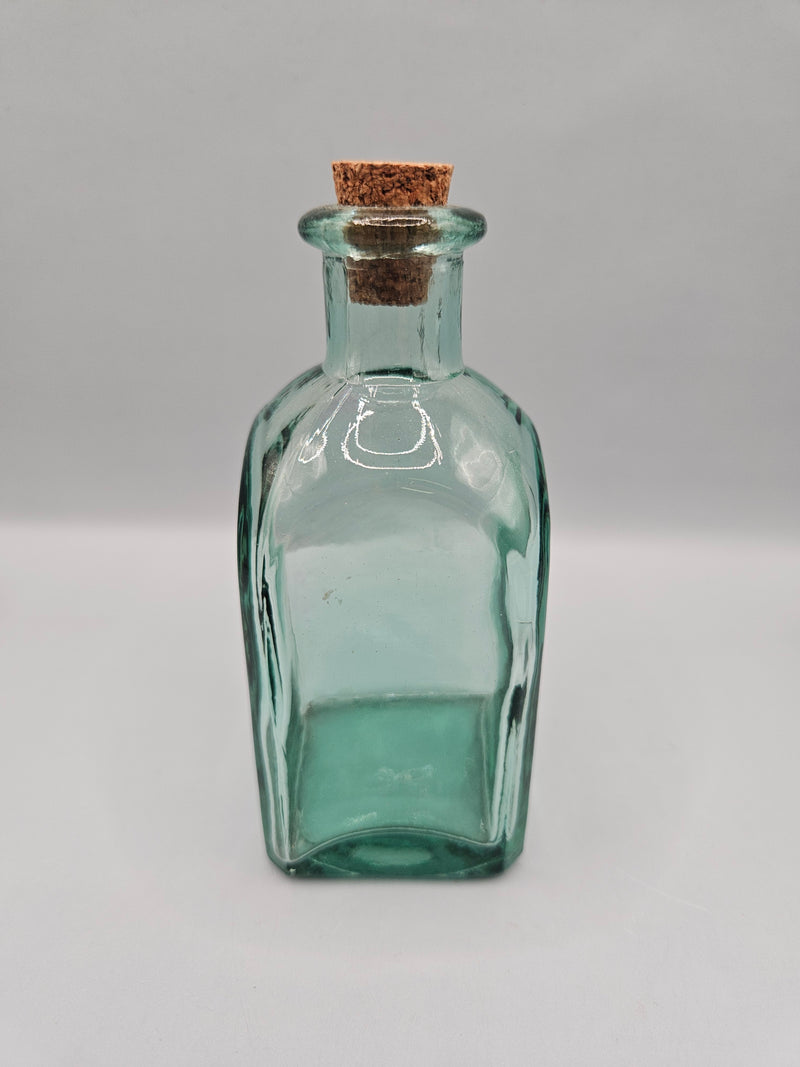 Vintage green glass bottle with cork stopper, 4.5 inches tall