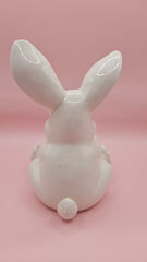 Vintage ceramic bunny rabbit holding a blue egg. 6