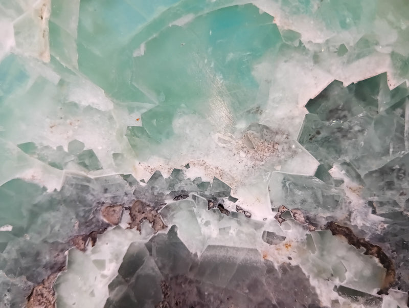Carved green and purple fluorite crystal bowl with raw edge