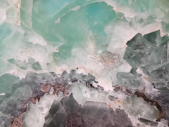 Carved green and purple fluorite crystal bowl with raw edge
