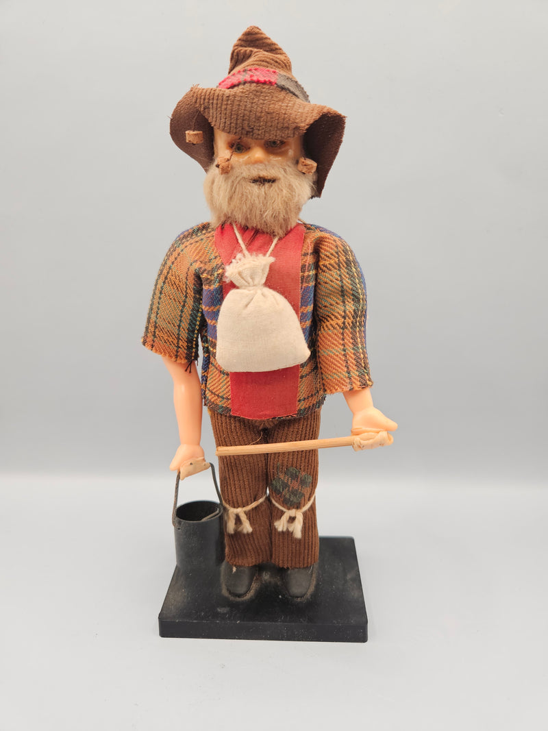 Close-up view of a vintage 8" Australian miner swagman doll, featuring a traditional hat, rugged clothing, and swag bag. The doll is a perfect representation of the iconic Australian Outback style.