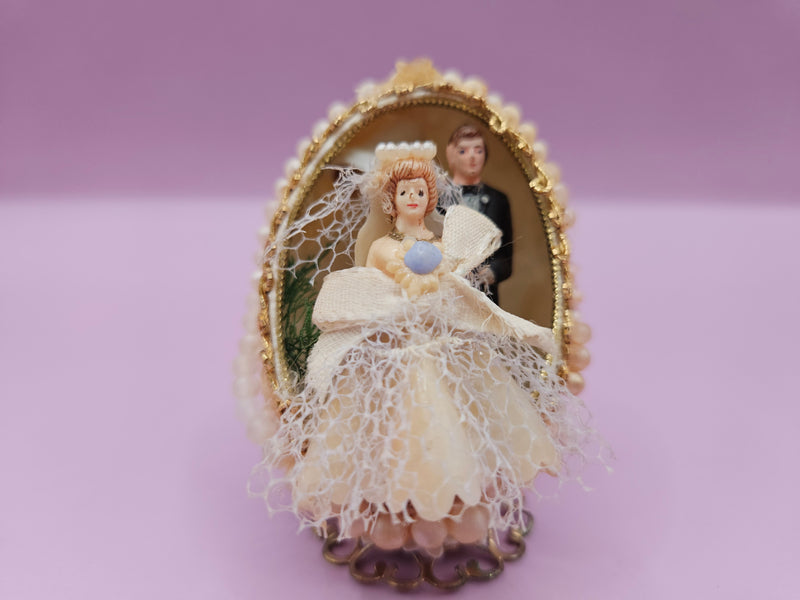 Vintage 1960s beaded egg diorama with wedding scene, pearl beads, and gold accents, Faberge-inspired, measuring 1.7 x 2.8 inches