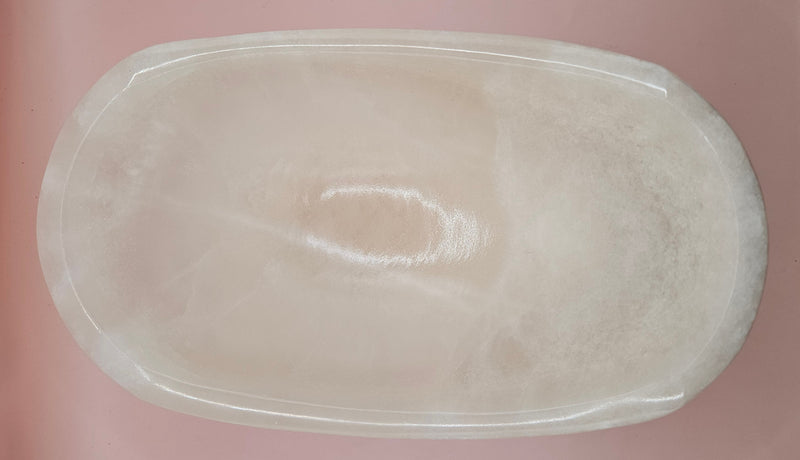 Polished white onyx bowl with smooth curves and a subtle translucent glow, measuring 9.75 inches.