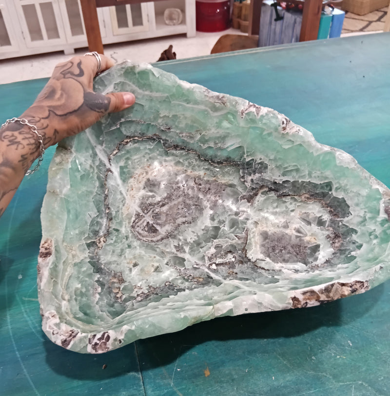 Carved green and purple fluorite crystal bowl with raw edge