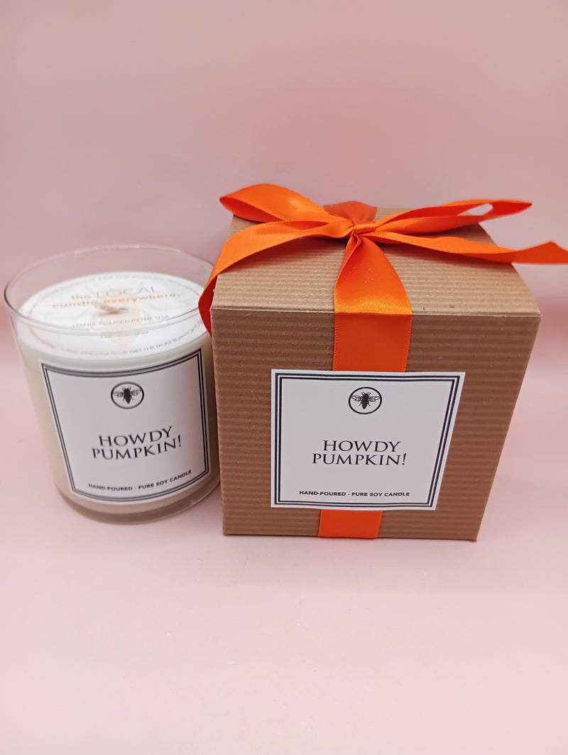 "Howdy Pumpkin!" soy candle in clear glass with black bee emblem