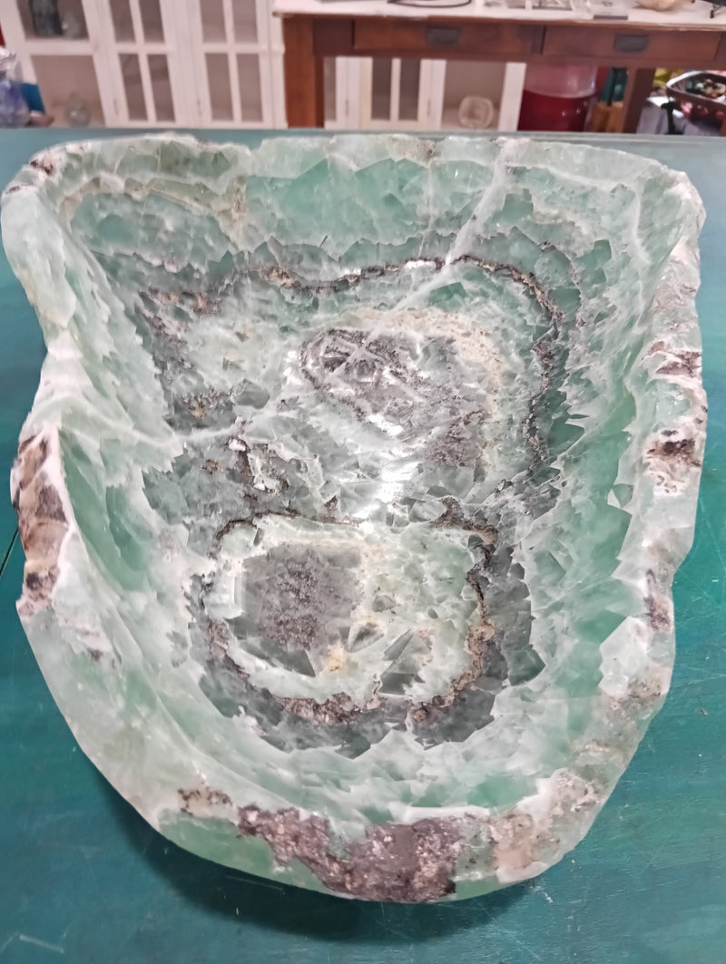 Carved green and purple fluorite crystal bowl with raw edge
