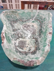 Carved green and purple fluorite crystal bowl with raw edge