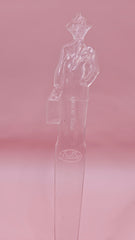 Vintage clear plastic Fuller Brush Man letter opener, shaped like a businessman holding a briefcase, measuring 7.25 inches long.