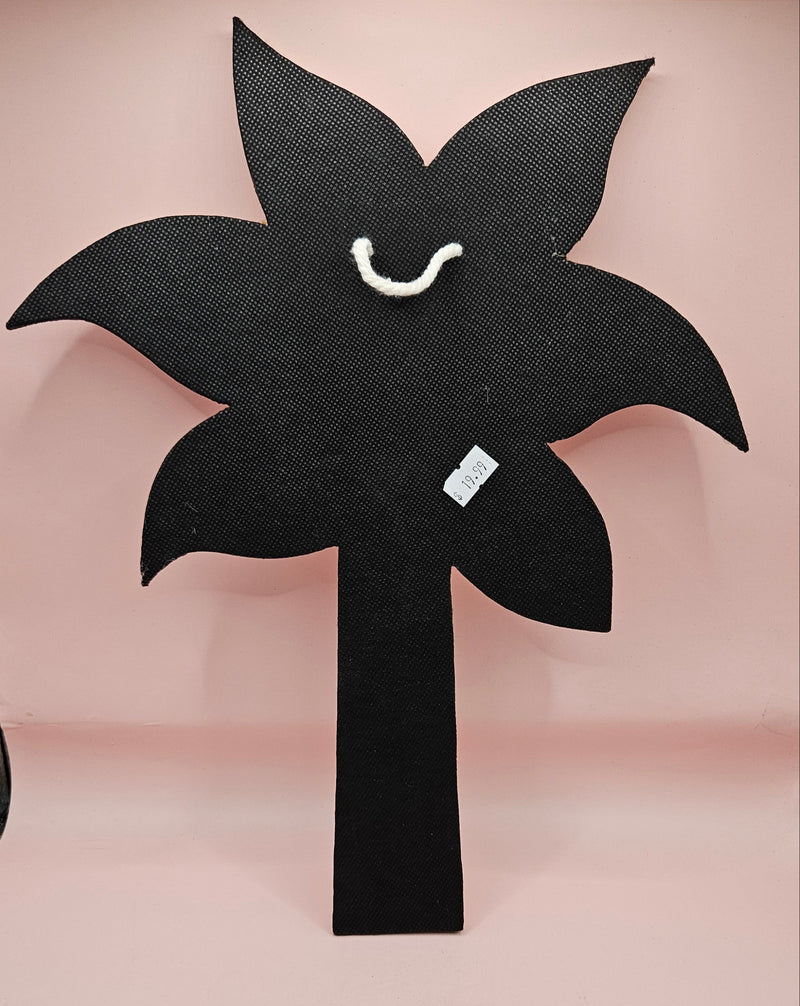Handmade palm tree wall art made of natural white shells with beaded detailing on a pink background.