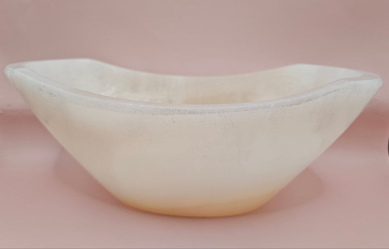 Polished white onyx bowl with smooth curves and a subtle translucent glow, measuring 9.75 inches.