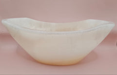 Polished white onyx bowl with smooth curves and a subtle translucent glow, measuring 9.75 inches.