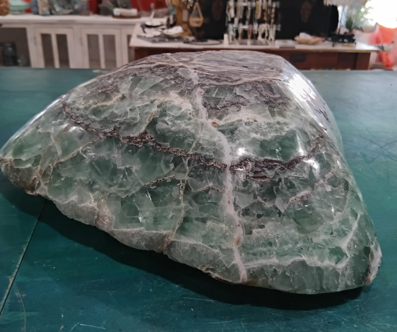 Carved green and purple fluorite crystal bowl with raw edge