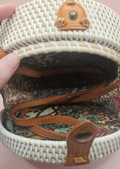 Round rattan crossbody bags in 4 styles—natural, pink, whitewash, and floral weave—with fabric-lined interior
