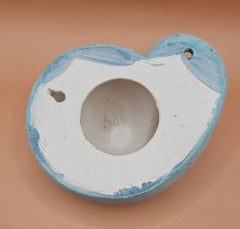 Two vintage ceramic shell wall hangings with pre-drilled holes, shown on a teal background, perfect for coastal décor or DIY projects.