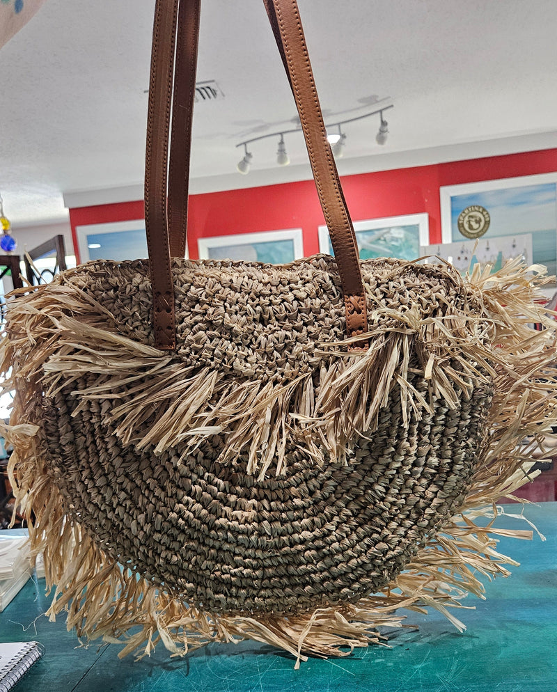 Handwoven round 16-inch straw tote bag with fringe and leather handles