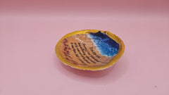 Handmade decorative shell with “Footprints” poem text, beach wave design, and golden painted rim, shown held in a hand.