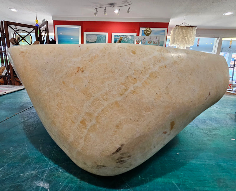 Oversized hand-carved onyx bowl in cream tones with natural marbling, measuring 20 inches wide.